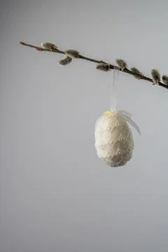 White pearled easter egg hanging from a willow twig with catkins Stock Photos