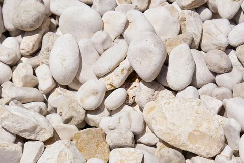 White pebbles background texture. Smooth round stones. Zen garden, spa, and Stock Photos