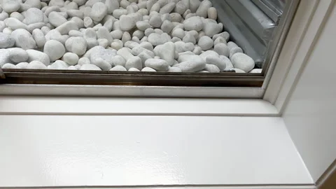 White Pebbles Lining the Bottom of Window Well Stock Footage 322081762