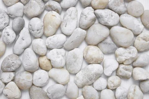 White pebbles stone texture background, View from above, closeup Фото