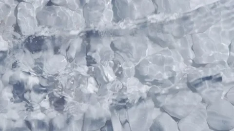 White pebbles under clean ripple water Stock Footage 256233670
