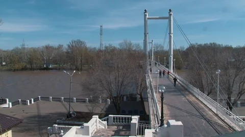 White pedestrian bridge crossing the Ural river Stock Footage 75013977