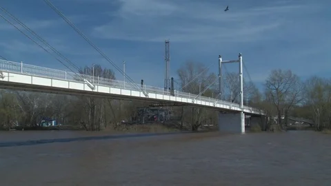 White pedestrian bridge crossing the Ural river Stock Footage 75015702