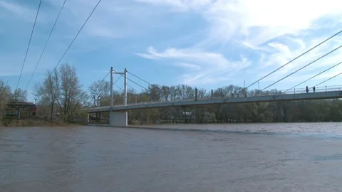 White pedestrian bridge crossing the Ural river Stock Footage 75016002