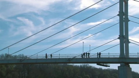 White pedestrian bridge crossing the Ural river Stock Footage 75016050