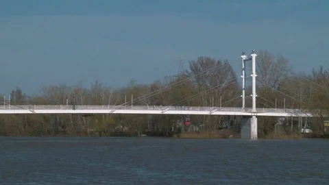 White pedestrian bridge crossing the Ural river Stock Footage 75016796