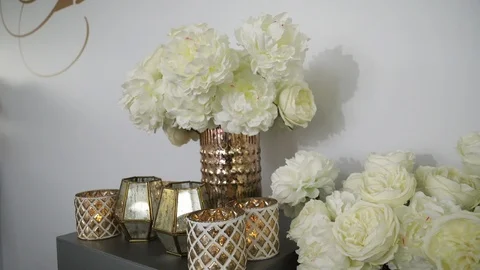 White peonies in gilded vases surrounded by candles in candlesticks. Stock Footage 122525532