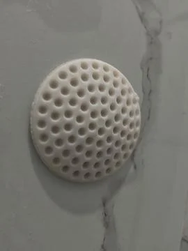 White Perforated Silicone Wall Protector or Drain Cover on Tile Stock Photos