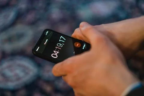 White person stops time with an IPhone Stock Photos