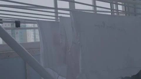 White personal things dry after washing on dryer on balcony Stock Footage 265774373