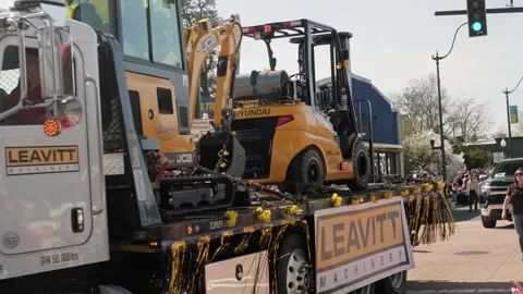 White Peterbilt flatbed truck carrying heavy machinery in the Sumn sammer egg 32 Stock Footage 339530876