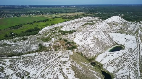 White Phosphogypsum Mountains Against The Backdrop Of Green Forest And Field Видео 339171974
