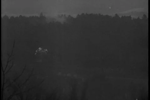 White phosphorous shells explode-on tree-covered hillside - 1944 Stock Footage 93019913