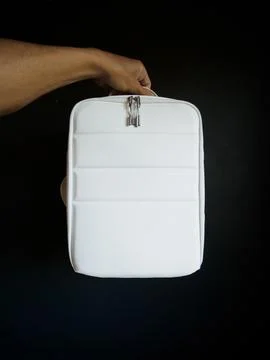White Photo Backpack in hand. Front view.. Stock Photos