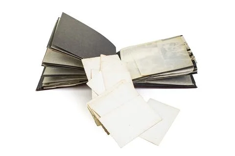 White photo backs stack, spilling out of a vintage photography album, isola.. Stock Photos