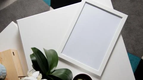 White photo frame on the table.  Stock Photos