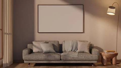 White photo frame on wall over grey sofa and wooden side table with evening.. Ilustração Stock