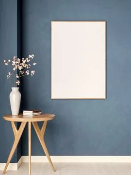 White photo or drawing frame hanging on blue wall over round wooden table w.. Ilustração Stock