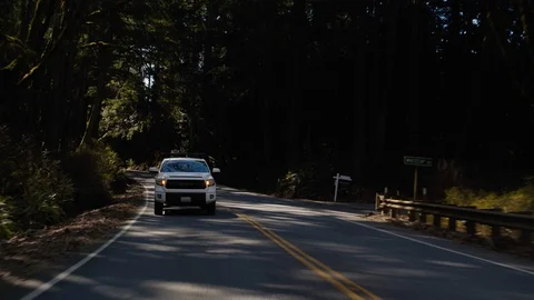 White Pickup Truck driving down coastal road in Northwest Washington State Stock Footage 87841023