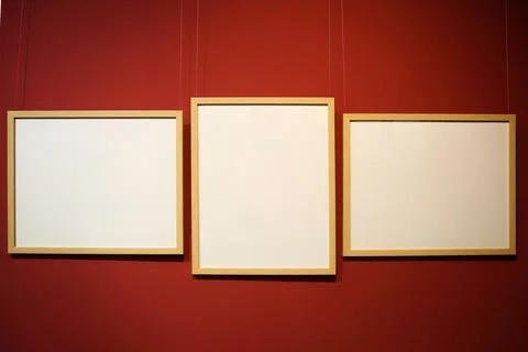 White picture frames on a red wall with copyspace Stock Photos