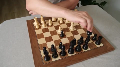 White pieces checkmate black king on a wooden chessboard Stock Footage 315089282