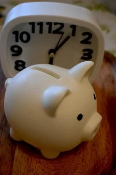 White Piggy Bank with Clock – Time and Savings Concept 库存照片