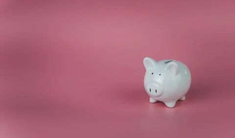 White piggy bank on a pink background. Savings and investment concepts. Stock Photos
