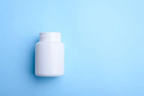 White pill bottle on light blue background Stock Photos