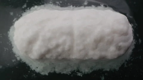 White pill dissolving in liquid Stock Footage 255671740