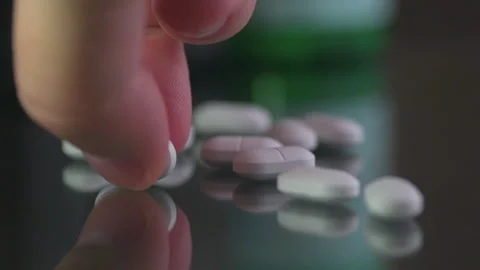White pill picked up by man's fingers, close up Stock Footage 255388944