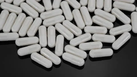 White Pill Tablet Capsule on black background, rotation Stock Footage 159120137