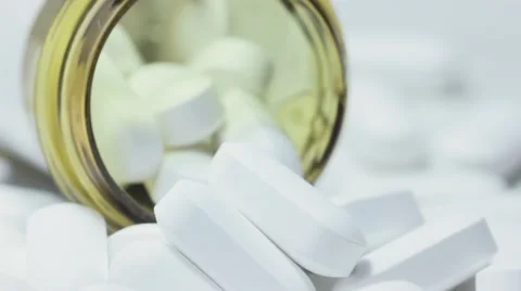 White Pill Tablets Overflowing out of a Pill bottle Stockbeeldmateriaal 68805902