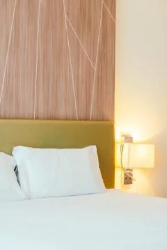 White pillow on the bed Stock Photos
