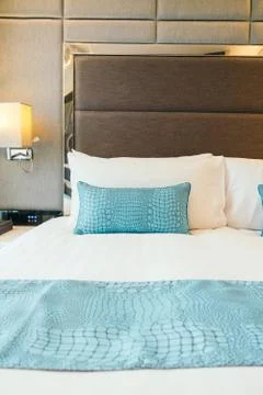 White pillow on the bed Stock Photos