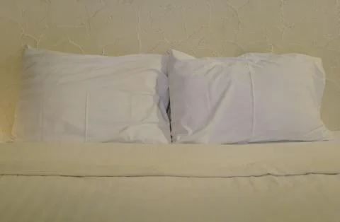 White pillows on bed Stock Photos