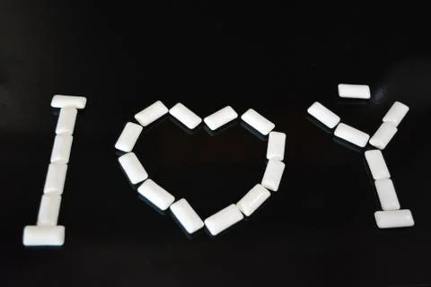 White pillows from chewing gum with reflection in the form of love I love you Stock Photos