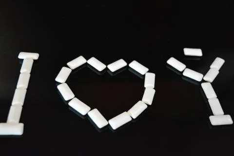 White pillows from chewing gum with reflection in the form of love I love you Stock Photos