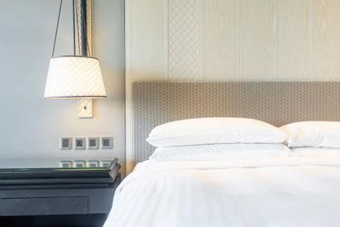 White pillows decoration on bed in bedroom Stock Photos
