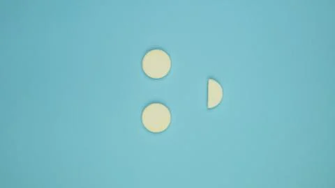 White pills on a blue gradient background with copy space in the form of a sm 스톡 사진
