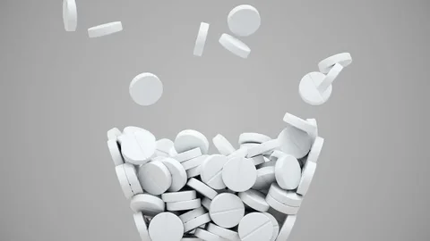 White pills fall and then pour out Stock Footage 82186229