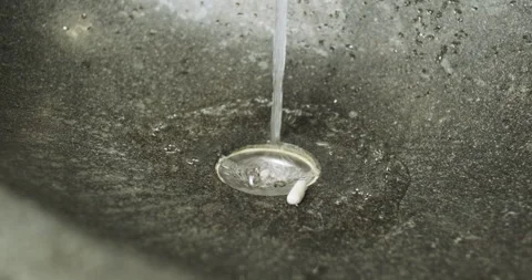 White pills fall into sink. Flush pills down the drain. Stream of water flows 動画素材 257668086