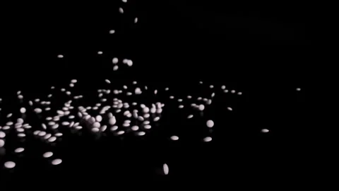 White pills falling on the ground. Stock Footage 252485092
