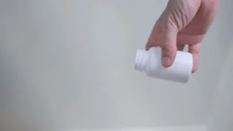 White pills falling on transparent surface Stock Footage 120208849