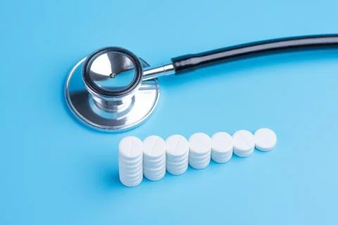 White pills or tablets stacked on each other in the form of steps and stethos Stock Photos