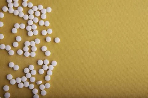 White Pills On Orange Surface 스톡 사진