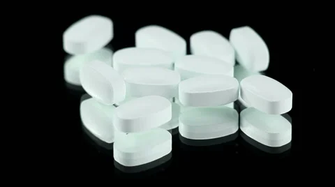 White Pills on a Rotating Black Background Stock-Footage 52211835