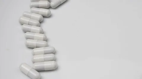 White, pills rotating, from the left side Stock Footage 81260200