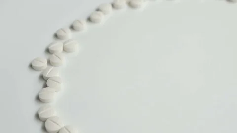 White pills rotating, from the left side on white background Stock Footage 83692226