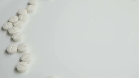 White pills rotating, from the left side on white background Stock Footage 83692227