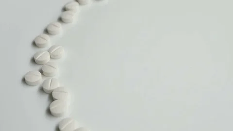 White pills rotating, from the left side on white background Stock Footage 83692237